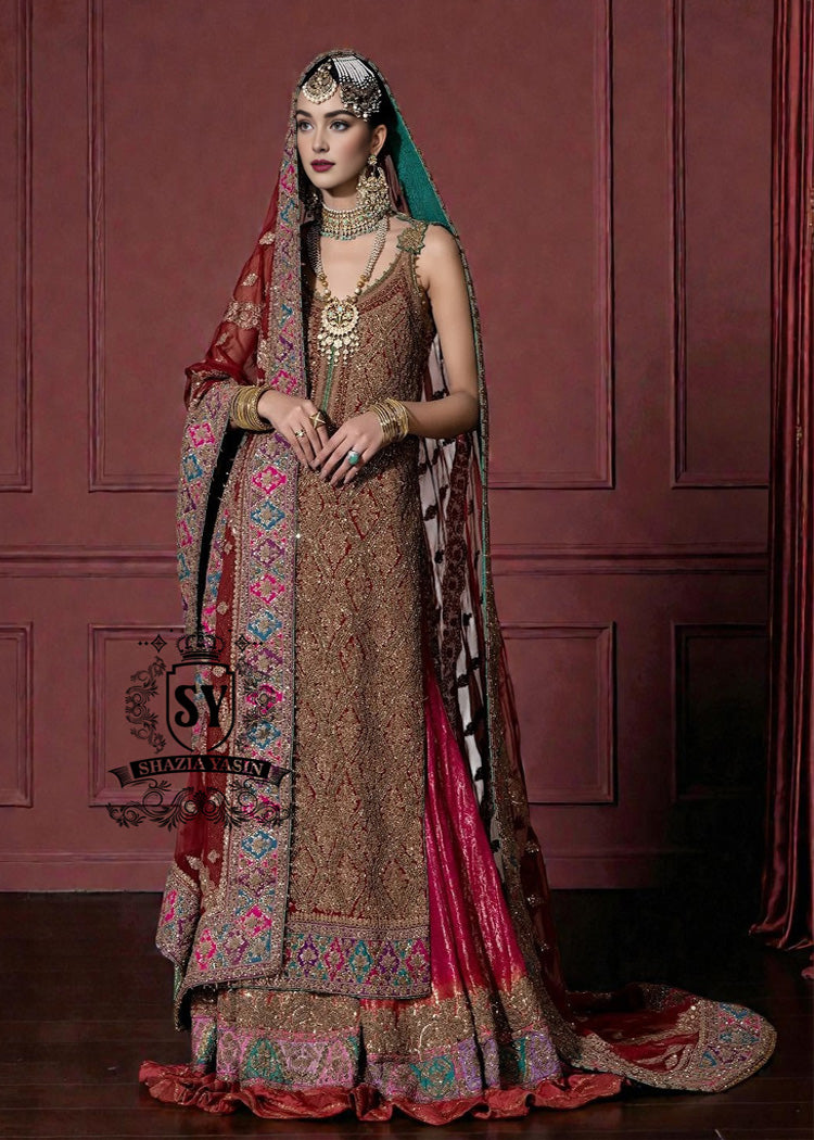Immerse yourself in the timeless brilliance of a Pakistani couture bridal lehenga. Vibrant traditional hues of red are lightly interwoven with shimmering gold, enveloping the bride in an aura of glamour and grace.
