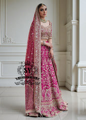 The Dogwood Rose bridal look evokes an aura of ancient majesty. A richly hand-embellished lehenga choli, structured yet flowing, sparkles with dabka details, stones, sequins, beads, silk threads, and Swarovski crystals. Paired with layered raw jewels and a striking jewel-pink dupatta, it captures the grandeur of old-world bridal elegance through a contemporary lens.