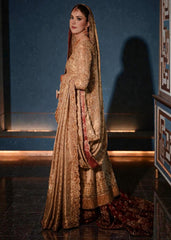 A vision of divine luminosity, this pishwas glimmers like starlight with every movement. Her Lehenga features intricate gold embroidery, delicate florals and crystal embellishments, while her lame dupatta envelops her like a dream.