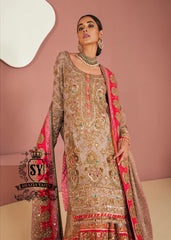 This luxurious, exclusive wedding dress from leading Pakistani designers shimmers with a noble glow in the light. Its majestic Gharara silhouette is perfect for a triumphant entrance, captivating the senses. This look exudes the hand of a true master who understands the value of true beauty.