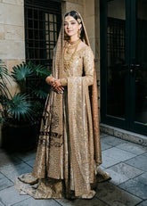 A majestic wedding dress made of luxurious Lame fabric in a lush farshi lehenga silhouette that radiates elegance. Long shirt creates an exquisite effect. The decor in the form of delicate flourishing embellishments adds romance.