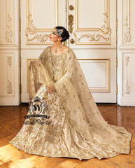Bride in a traditional Ivory Hand Embellished wedding dress with sheer sleeves and floral decorations sitting in a decoratively paneled room.