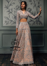 This bespoke bridal Lehenga choli dress is a celebration of romance and craftsmanship — adorned with tens of thousands of hand-sewn crystals that glisten like stardust on layers of ethereal tulle.