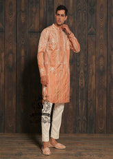 Expertly embroidered for a sophisticated look, the SY Couture Peach Men's Kurta Pajama is the perfect blend of style and comfort. Made with high-quality fabric, it features an elegant design and superior stitching for a lasting impression. Elevate your wardrobe with this timeless piece for any occasion.