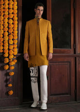 Adorn yourself in elegant attire with this Geebung-colored raw silk prince coat. The matching inner kurta and Off-White pajamas create a perfect match. Ideal for grooms.