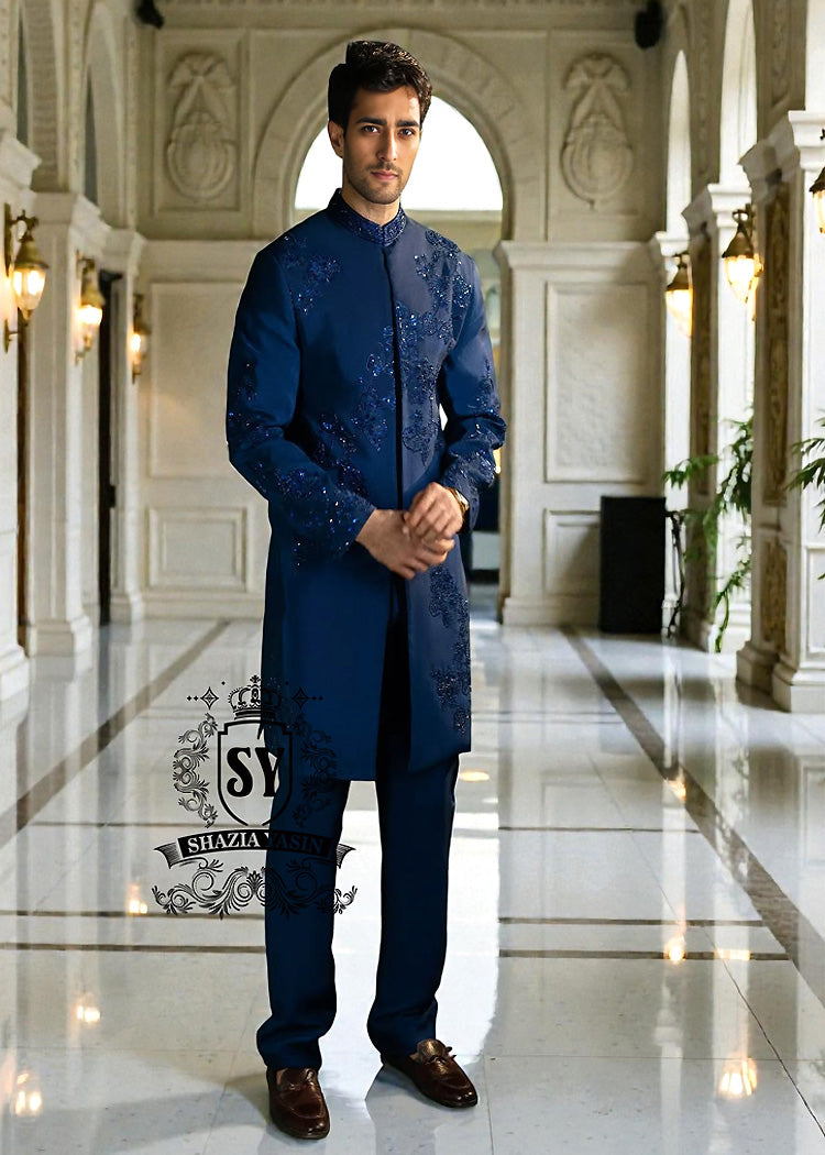 This Admiral Blue sherwani redefines elegance with its intricately executed tone-on-tone adah work, exuding a royal aura with a distinctive modern edge, embodying royal sophistication yet suited to the modern man.