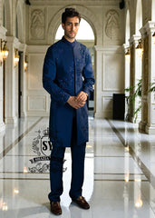 This Admiral Blue sherwani redefines elegance with its intricately executed tone-on-tone adah work, exuding a royal aura with a distinctive modern edge, embodying royal sophistication yet suited to the modern man.