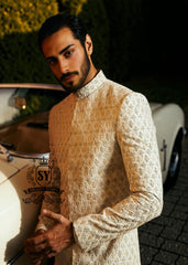 Pure royalty. A finely hand-embroidered sherwani by Shazia Yasin, elevated with gold accents, paired with a statement mala and a bold crimson turban for a timeless yet striking look.