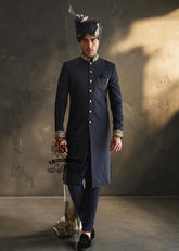 Indulge in a blissful moment with the beautiful Jets Navy Embellished Sherwani For Wedding, crafted from high-quality Jamawaar fabric. Perfect for any wedding occasion, this sherwani will make you shine on your special day.