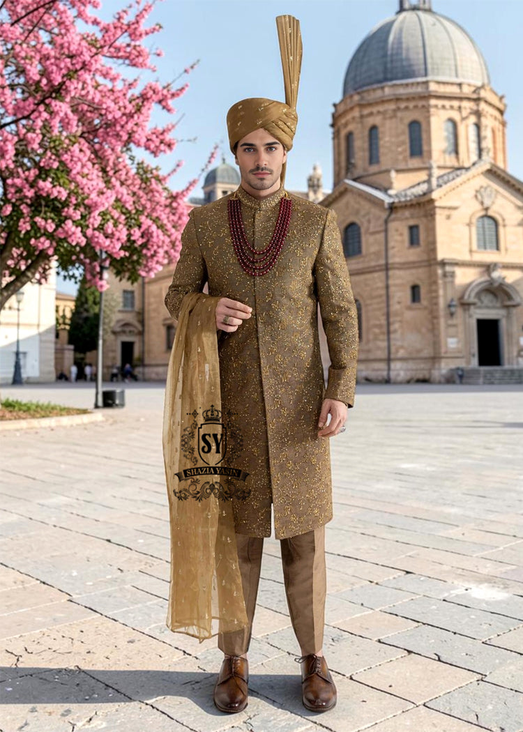 For the noble groom, a sophisticated and sharp Quartz Ochre sherwani, crafted from luxurious masoori net and adorned with exquisite jewels and timeless Zari embroidered floral motifs, was layered over a Quartz Ochre colored kurta set.