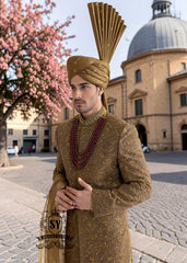 For the noble groom, a sophisticated and sharp Quartz Ochre sherwani, crafted from luxurious masoori net and adorned with exquisite jewels and timeless Zari embroidered floral motifs, was layered over a Quartz Ochre colored kurta set.
