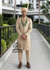 In the grandeur of royal legacy, this Taupe Gold sherwani stands as a tribute to timeless nobility. Handcrafted with intricate embroidery that echo strength and majesty, it glimmers with the delicate artistry of sequins, Swarovski crystals. A creation where tradition meets elegance - designed for the groom who carries the spirit of heritage with the poise of modern royalty.