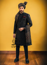 Wrapped in a rich black Sherwani with lustrous Self-embroidery and precise tailoring, this Sherwani defines luxury. A perfect balance of refinement, confidence and iconic black.