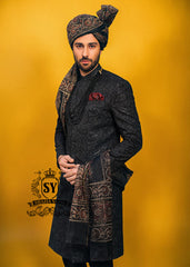 Wrapped in a rich black Sherwani with lustrous Self-embroidery and precise tailoring, this Sherwani defines luxury. A perfect balance of refinement, confidence and iconic black.