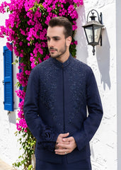 A stylish waistcoat crafted from luxurious navy blue raw silk fabric. The waistcoat itself, the front, and the sleeves are adorned with intricate threadwork and embroidery, giving it a refined and traditional feel.