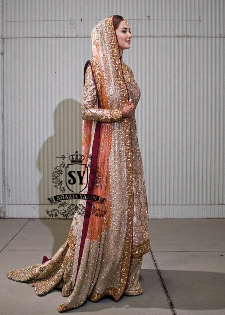 Charming A-line wedding dress with long Fully embellished sleeves and a boat neckline, with a voluminous princess-style lehenga skirt with a spectacular train.