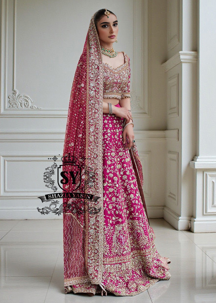 The Dogwood Rose bridal look evokes an aura of ancient majesty. A richly hand-embellished lehenga choli, structured yet flowing, sparkles with dabka details, stones, sequins, beads, silk threads, and Swarovski crystals. Paired with layered raw jewels and a striking jewel-pink dupatta, it captures the grandeur of old-world bridal elegance through a contemporary lens.