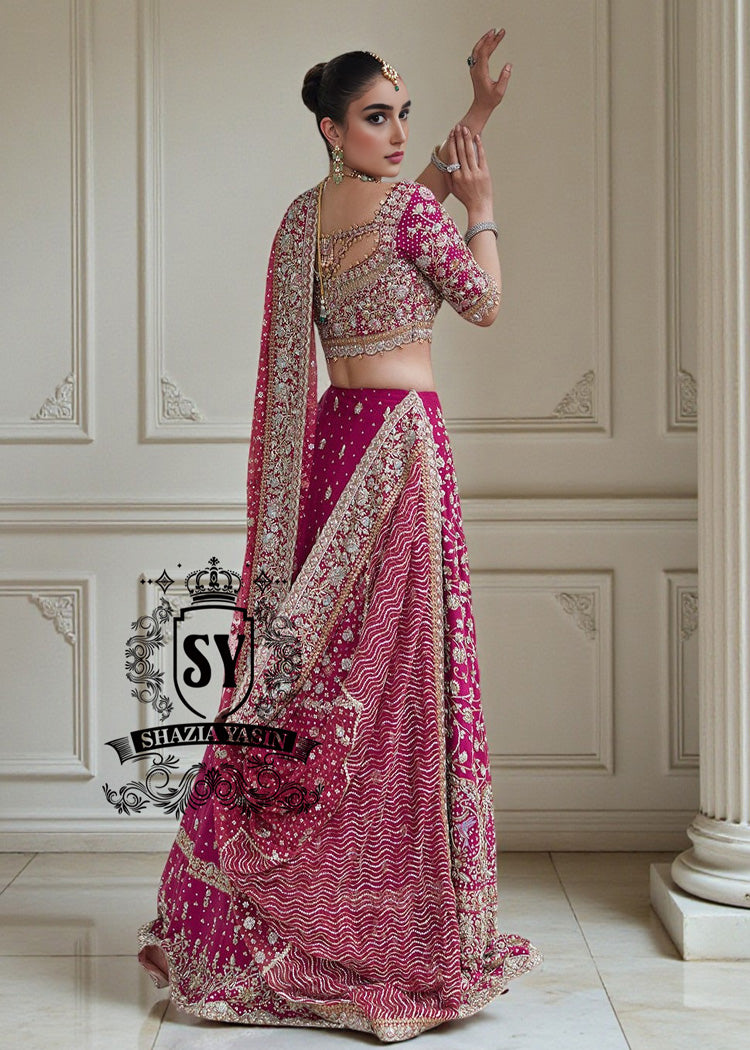 The Dogwood Rose bridal look evokes an aura of ancient majesty. A richly hand-embellished lehenga choli, structured yet flowing, sparkles with dabka details, stones, sequins, beads, silk threads, and Swarovski crystals. Paired with layered raw jewels and a striking jewel-pink dupatta, it captures the grandeur of old-world bridal elegance through a contemporary lens.