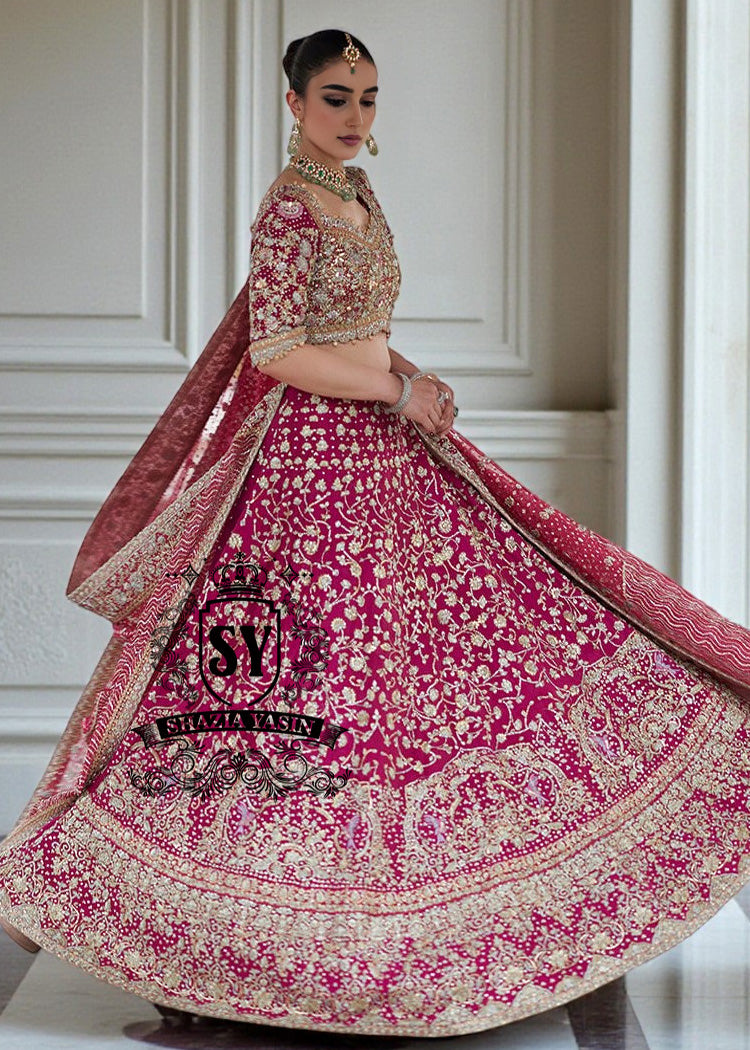 The Dogwood Rose bridal look evokes an aura of ancient majesty. A richly hand-embellished lehenga choli, structured yet flowing, sparkles with dabka details, stones, sequins, beads, silk threads, and Swarovski crystals. Paired with layered raw jewels and a striking jewel-pink dupatta, it captures the grandeur of old-world bridal elegance through a contemporary lens.