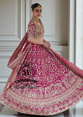 The Dogwood Rose bridal look evokes an aura of ancient majesty. A richly hand-embellished lehenga choli, structured yet flowing, sparkles with dabka details, stones, sequins, beads, silk threads, and Swarovski crystals. Paired with layered raw jewels and a striking jewel-pink dupatta, it captures the grandeur of old-world bridal elegance through a contemporary lens.