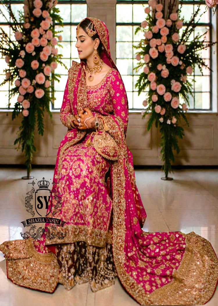 A timeless bridal dress design that exudes classic elegance and meticulous craftsmanship. The intricately crafted, opulent Banarsi Jamawar lehenga exudes a royal flair, with its heavy maroon and red borders creating a magnificent, flowing train.