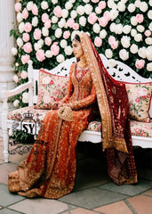 A traditional Pakistani bride epitomizes royal elegance in our newest bridal Pishwas Lehenga dress.