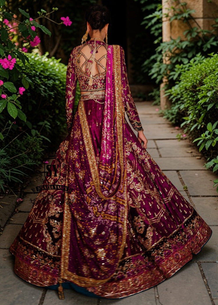 This striking two-tone Berry and Berry Burgundy lehenga choli is heavily embellished with shimmering gold handwork and harmonious silk threadwork for a modern classic look. The luxurious bodice is hand-embellished with diamante detailing, making you stand out in the crowd.