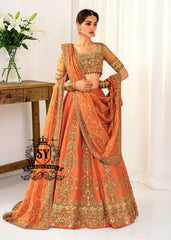 A stunning ensemble featuring Persimmon net blouse and an intricately embroidered Raw silk lehenga in the same vibrant hue. A shimmering kaamdani dupatta adds charm and sophistication to the ensemble.