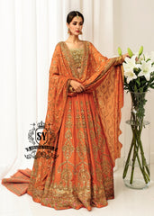 A stunning ensemble featuring Persimmon net blouse and an intricately embroidered Raw silk lehenga in the same vibrant hue. A shimmering kaamdani dupatta adds charm and sophistication to the ensemble.