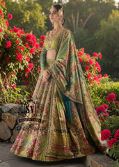 A stunning dark apple green lehenga featuring digital print and luxurious embroidery. The Choli Blouse is hand-applied with intricate floral appliqués, giving it a glamorous look. 