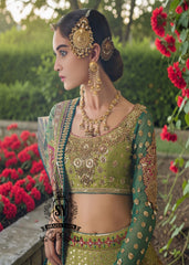 A stunning dark apple green lehenga featuring digital print and luxurious embroidery. The Choli Blouse is hand-applied with intricate floral appliqués, giving it a glamorous look. 