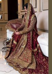 A wedding dress with a long train lehenga embroidered with crystals, created for an unparalleled look for the bride. The delicate embellishments softly sparkles with every movement, while the wedding gown silhouette beautifully highlights her natural elegance.