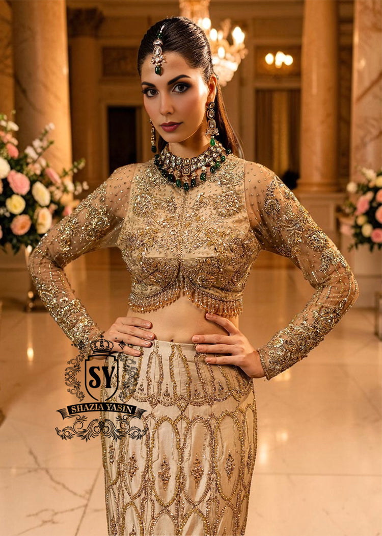 Ivy is a mermaid wedding dress that fascinates with the refinement of its lehenga silhouette, which delicately follows the lines of the body and highlights a timeless elegance. The blouse of the dress is outlined by a embellished neckline, while the long sleeves, made entirely of net with shiny floral embellishments, add an extra touch of sophistication.
