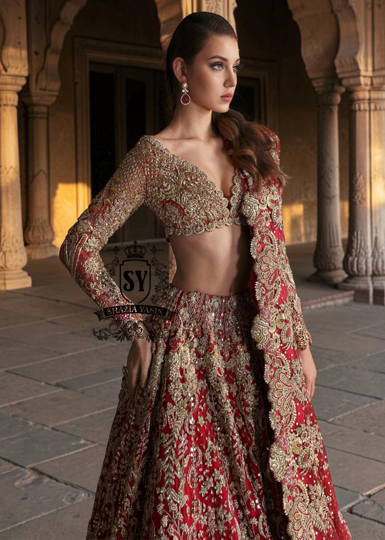 This Angels Red bridal dress is the epitome of grace and grandeur — a wedding lehenga choli dress crafted to perfection for your big day. Full of shine and feminine charm, this is a perfect choice for brides who want to subtly shine on their big day.