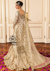 Ivory Heavily Embellished wedding dress with open back and full farshi gharara skirt, seen from behind.