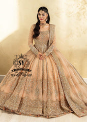 In a radiant shade of Peach puff, this bridal dress captures a timeless grandeur, sweetened with touches of pastel romance. This open-cut kalidaar gown shines with tissue silk lehenga.