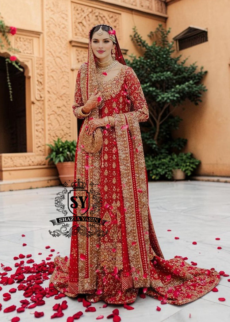 Radiating pure Amaranth Red bridal dress magic with two legged farshi lehenga. A perfect balance of grandeur and simplicity.