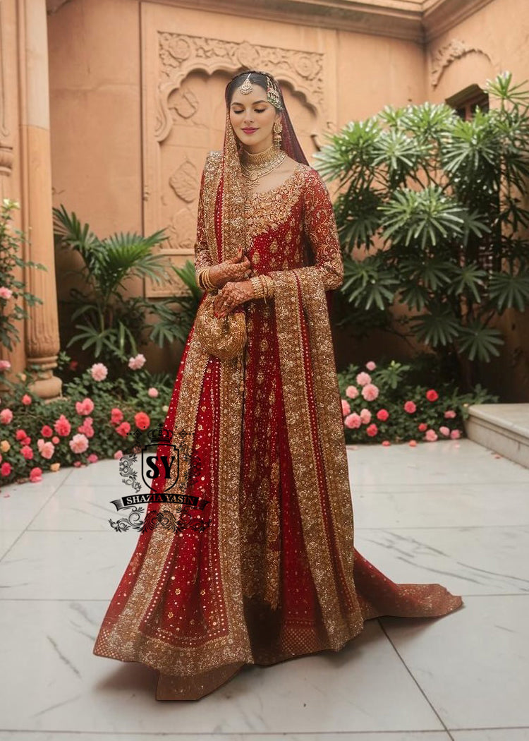 Radiating pure Amaranth Red bridal dress magic with two legged farshi lehenga. A perfect balance of grandeur and simplicity.