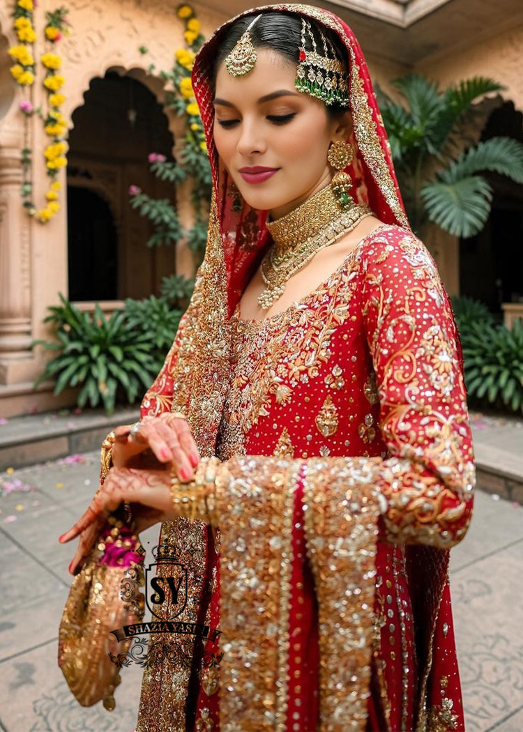Radiating pure Amaranth Red bridal dress magic with two legged farshi lehenga. A perfect balance of grandeur and simplicity.