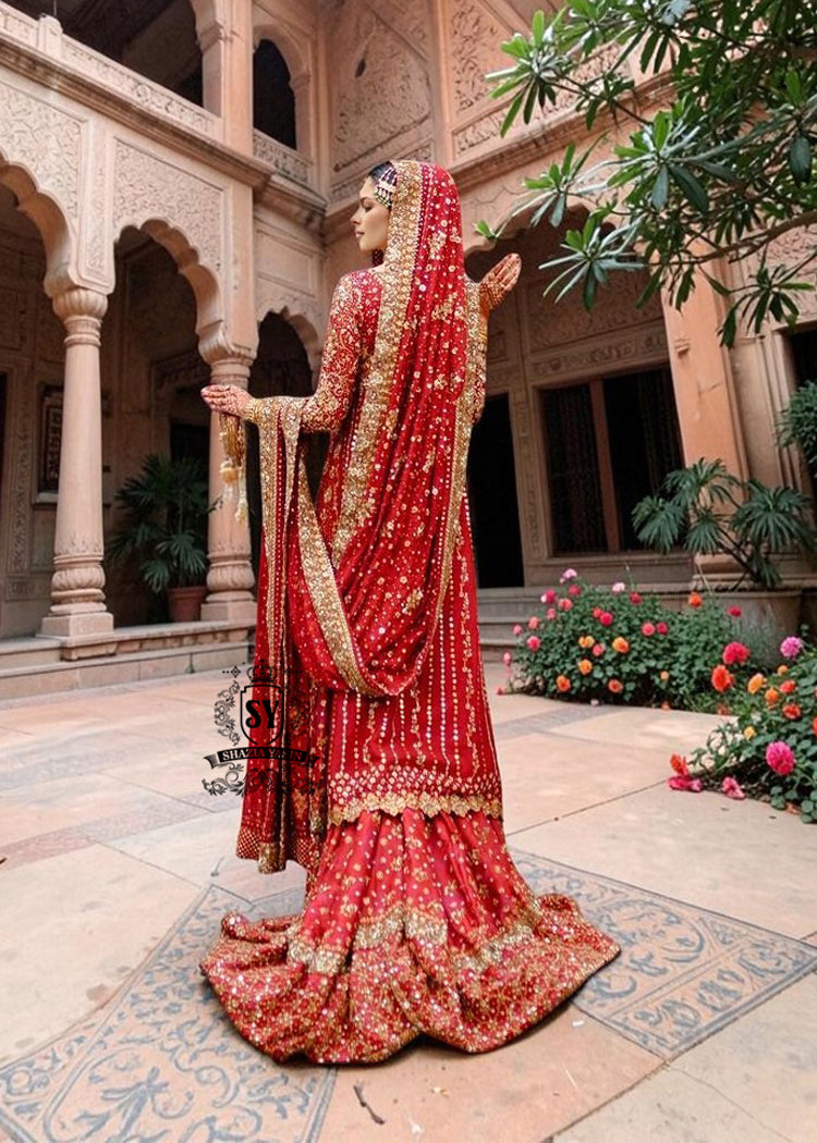 Radiating pure Amaranth Red bridal dress magic with two legged farshi lehenga. A perfect balance of grandeur and simplicity.
