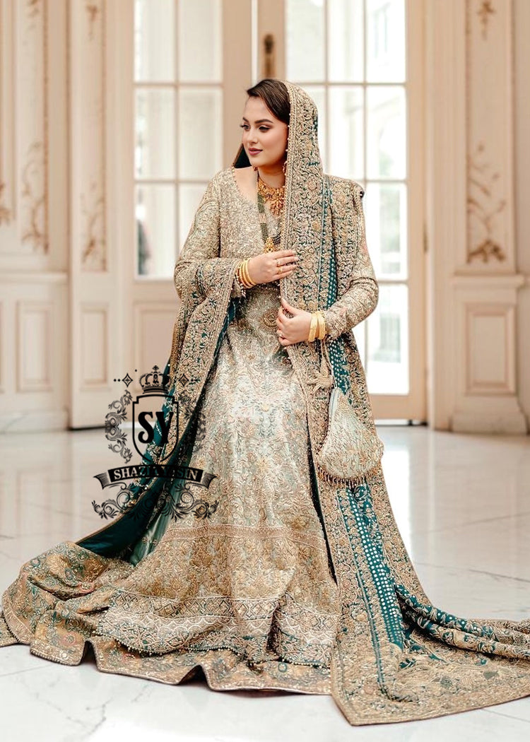 A royal look for a Full-figured bride will be created by this A-line long shirt with farshi lehenga dress made of luxurious lame fabric in Tradewind color.