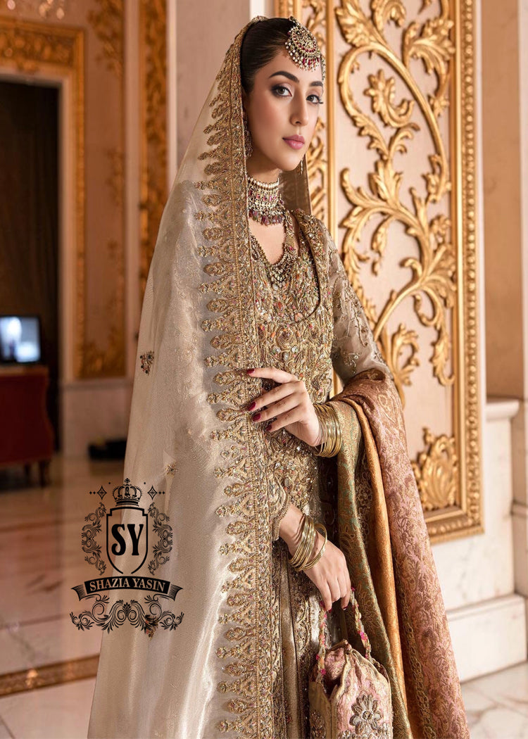A Pakistani wedding dress is a captivating sight. Let your dreams become your wings in a wedding dress. This rich Beige gold maxi dress is adorned with carefully placed vibrant motifs, each crafted using tilla, kora Dabka, stones, sequins, beads, silk threads and swarovski crystals, and zardozi techniques.