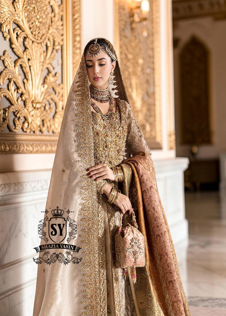 A Pakistani wedding dress is a captivating sight. Let your dreams become your wings in a wedding dress. This rich Beige gold maxi dress is adorned with carefully placed vibrant motifs, each crafted using tilla, kora Dabka, stones, sequins, beads, silk threads and swarovski crystals, and zardozi techniques.
