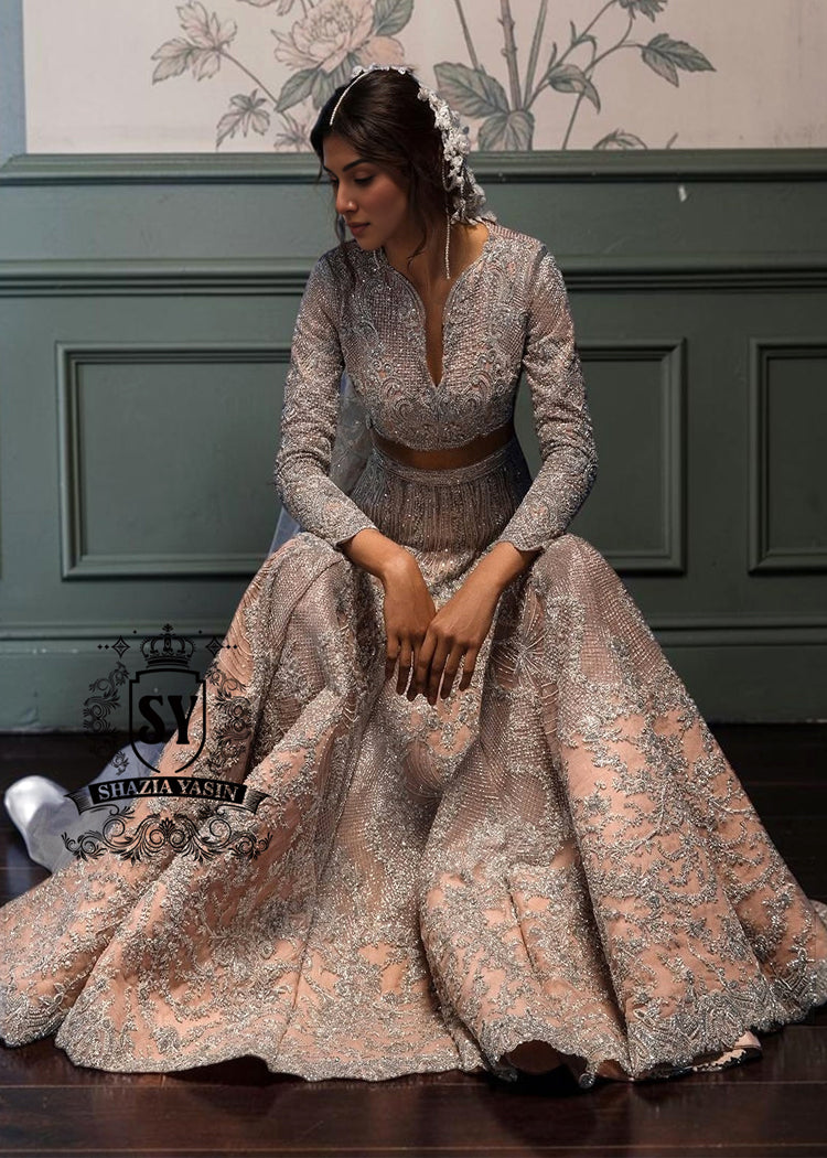 Bride in a bespoke bridal Lehenga choli dress is a celebration of romance and craftsmanship — adorned with tens of thousands of hand-sewn crystals that glisten like stardust on layers of ethereal tulle.