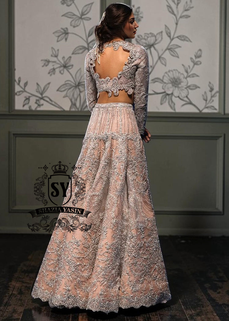 This modern open-back design bespoke bridal Lehenga choli dress is a celebration of romance and craftsmanship — adorned with tens of thousands of hand-sewn crystals that glisten like stardust on layers of ethereal tulle.