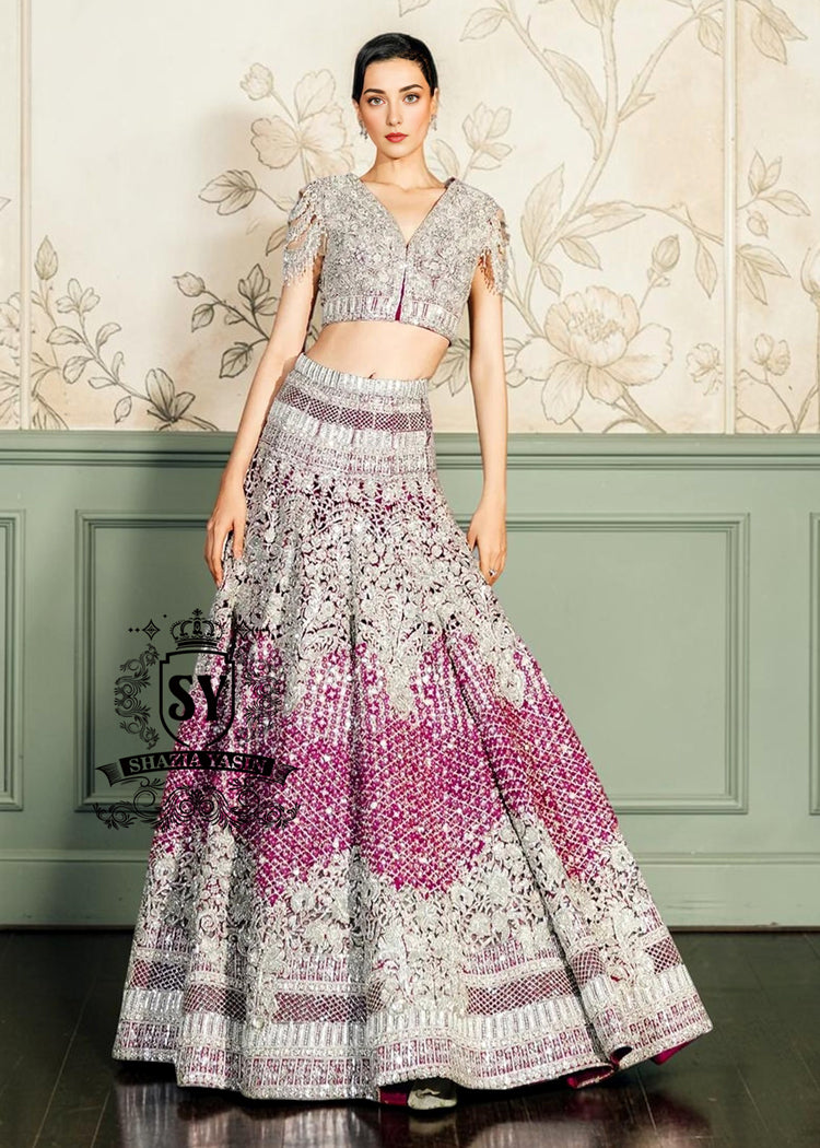 This Amaranth purple Lehenga choli Bridal dress is the embodiment of royal grandeur. A stunning wedding dress, every detail of which is designed to captivate. Exquisite embellishments, a sophisticated blouse, luxurious Beaded sleeves, and a delicate neckline create a truly aristocratic bride.