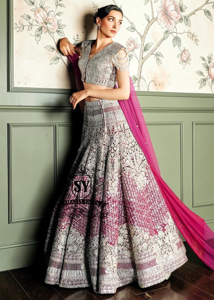 Royal Amaranth purple Lehenga choli Bridal dress is the embodiment of royal grandeur. A stunning wedding dress, every detail of which is designed to captivate. Exquisite embellishments, a sophisticated blouse, luxurious Beaded sleeves, and a delicate neckline create a truly aristocratic bride.