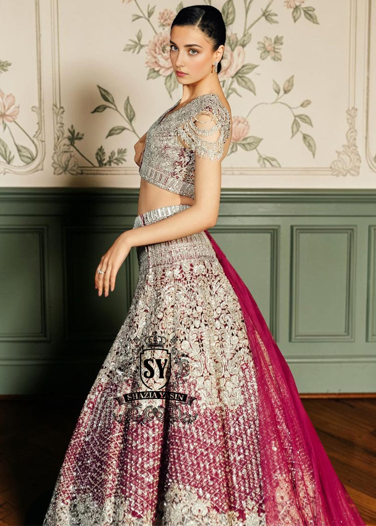 This Amaranth Lehenga choli Bridal dress is the embodiment of royal grandeur. A stunning wedding dress, every detail of which is designed to captivate. Exquisite embellishments, a sophisticated blouse, luxurious Beaded sleeves, and a delicate neckline create a truly aristocratic bride.