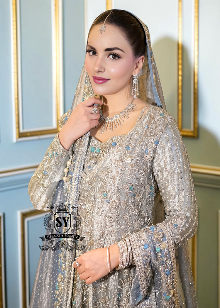 Discover Shazia Yasin’s Silver Chalice Bridal Dress with Blue Haze Lehenga, exquisitely embellished with silver zardozi and crystal embroidery. Perfect for engagement, Nikah or walima brides, this outfit captures royal tradition and luxury.