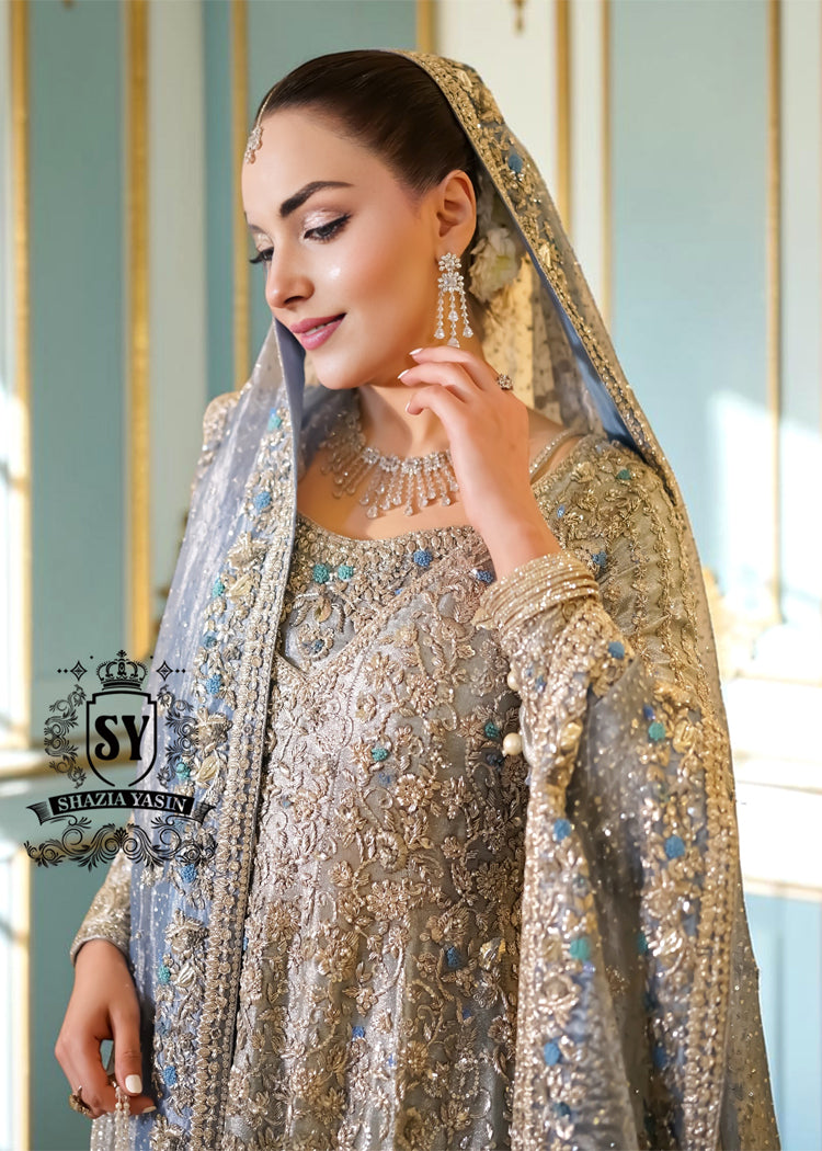 Discover Shazia Yasin’s Silver Chalice Bridal Dress with Blue Haze Lehenga, exquisitely embellished with silver zardozi and crystal embroidery. Perfect for engagement, Nikah or walima brides, this outfit captures royal tradition and luxury.
